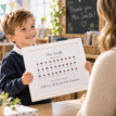 Child receiving a personalised ladybird teacher gift print in classroom.