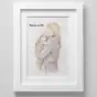 Personalised watercolour portrait of a woman holding a child, framed and displayed on a wall.